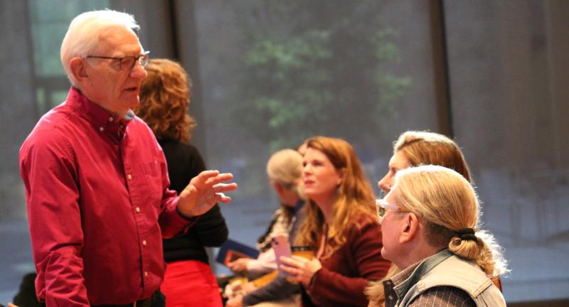Audience members talk during a break